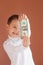 Boy holds money in his hands, one dollar in the hands