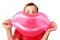Boy holds toy, inflatable pink lips.