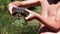 Boy Holds Turtle in Arms on Background of a River with Green Vegetation