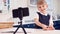 Boy At Home Wearing School Uniform With Model Of Wind Turbine Recording Video About Green Energy