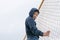 A boy in a hood climbed a fence from a net, street children