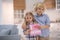 Boy hugging girl, both kids holding sign