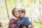 Boy hugging mother outside in spring