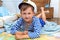 boy in the image of a sailor playing in his room. examines through a magnifying glass card