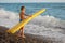 Boy with inflatable mattress stands on seacoast