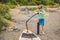 Boy inflate sup surfboard with pump on beach. Happy family childhood lifestyle. Summer nature outdoor individual aquatic