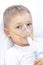 Boy with an inhaler mask - respiratory problems in asthma.