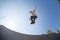 Boy with inline skates, rollerblade, doing a jump in a skate park