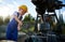 Boy with instrument fixing drilling rig