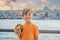 Boy in Istanbul having breakfast with Simit and a glass of Turkish tea. Glass of Turkish tea and bagel Simit against