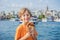 Boy in Istanbul having breakfast with Simit and a glass of Turkish tea. Glass of Turkish tea and bagel Simit against