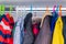 Boy jackets hanging in a closet with colorful hangers