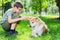 Boy with Japanese dog Akita inu in the park