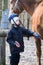 Boy Jockey caring for their horse