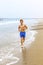 Boy jogging along the beach