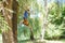 Boy jumping from a big tree down, wide angle photo