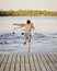 Boy jumping into lake