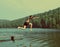 Boy jumping in lake - vintage retro style