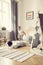 Boy jumping on a mattress in a cozy playroom interior