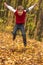 Boy jumping in the outumn forrest