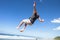 Boy Jumping Somersault Blue Sky