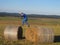 Boy jumping on the straw bales