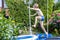 Boy jumping from trampoline into swimming pool