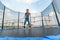 The boy jumps on a trampoline in an amusement park, performing various stunts