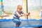 A boy jumps on a trampoline in an extreme sports park