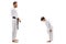 Boy in karate kimono bowing to instructor