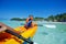 Boy kayaking at tropical sea on yellow kayak