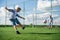 Boy kicking a penalty at goal. Low angle wide view.