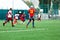 Boy is kicking soccer ball. Boy is running after the ball on green grass. footballer in white and red shirt. boys dribbling.