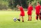 Boy kicking soccer ball at training