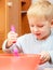 Boy kid baking cake. Child beating dough with wire whisk. Kitchen.