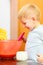 Boy kid baking cake. Child beating dough with wire whisk. Kitchen.