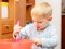 Boy kid baking cake. Child beating dough with wire whisk. Kitchen.