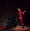 Boy kid catches snowflakes with his palm holding in one hand a Christmas tree