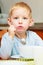 Boy kid child eating corn flakes breakfast morning meal at home.