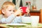 Boy kid child eating corn flakes breakfast playing mobile phone