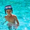 Boy kid child eight years old inside swimming pool portrait happy fun bright day diving goggles square