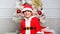 Boy kid dressed as cute elf magical creature white artificial ears and red hat near christmas tree. Christmas elf