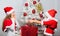 Boy kid dressed as santa with white artificial beard and red hat give gift box to girl. Santa bring some gifts