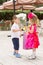 The boy kid gives flowers to girl child on birthday.