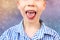 Boy, kid opened his mouth, oral cavity, close-up teeth, performs articulation exercises for the tongue, vocals, dental concept,