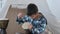 Boy kid playing on traditional african drums