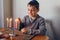 Boy in kippah lighting candles on menorah for traditional winter Jewish Hanukkah holiday. Child celebrating Chanukah festival of