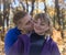 Boy kissing girl in autumn forest