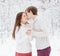 Boy kissing girl in winter forest