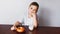 A boy, a kitchen, a bagel and milk. Healthy breakfast.